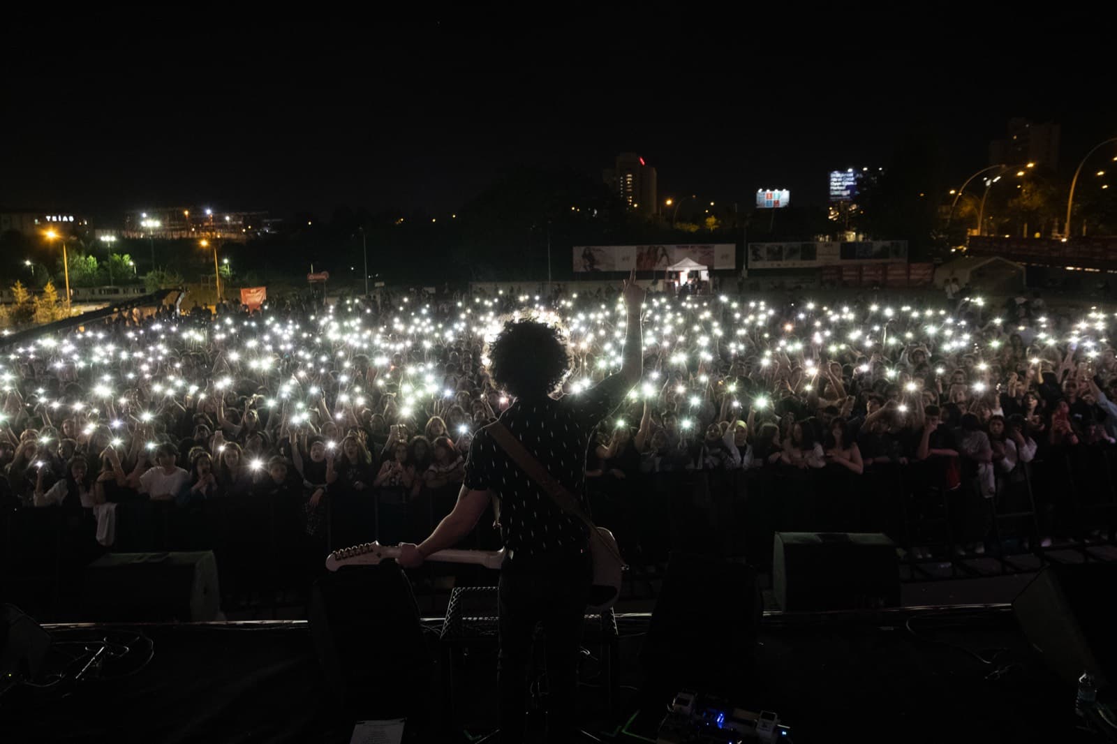 A night concert filling with phone lights