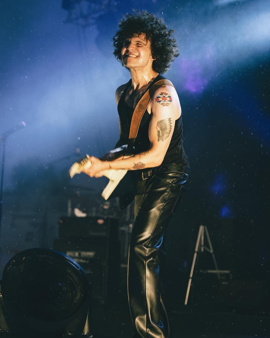 Batu Akdeniz smiling under blue stage lights